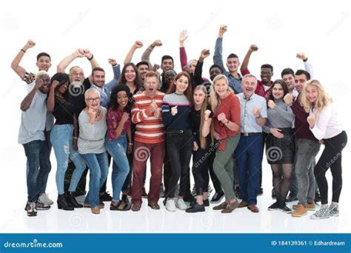 a group of people standing in a room with a robot