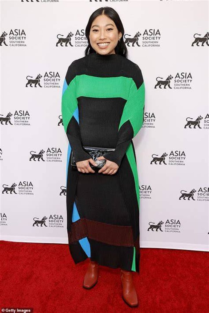 Awkwafina wears a modest striped dress as she attends Asia Society