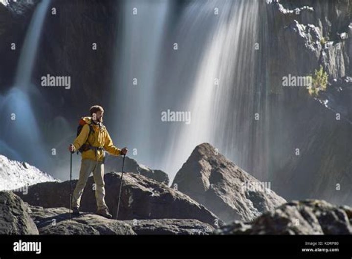 backpacker looking at waterfall in iceland