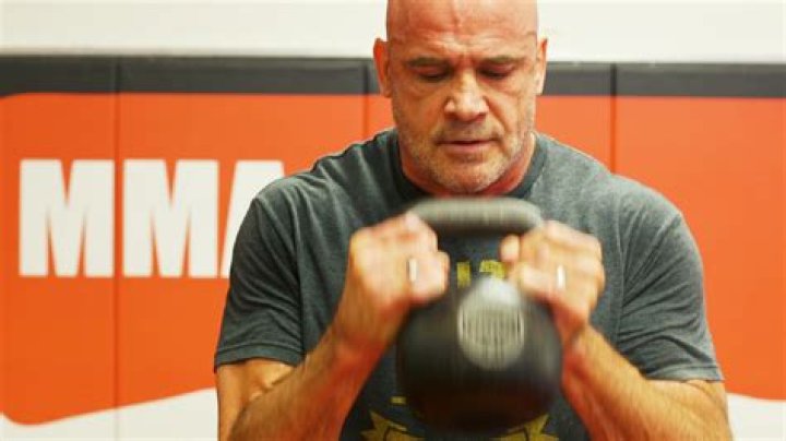 Bas Rutten Strikes A Punching Bag