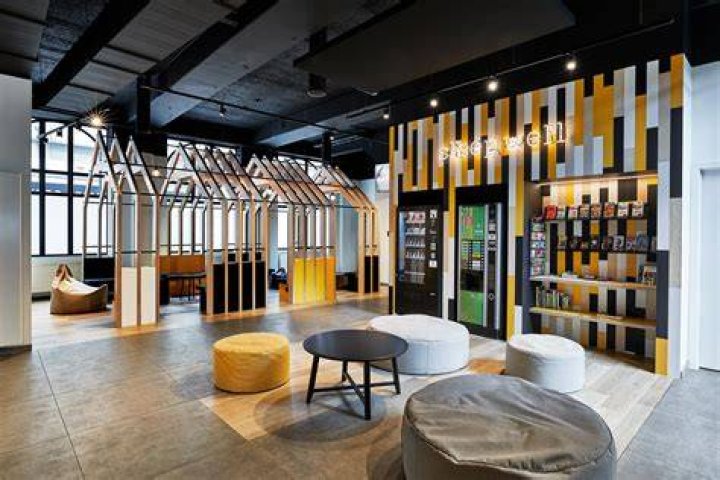 check in lobby at hostel full of colorful suitcases and a guitar