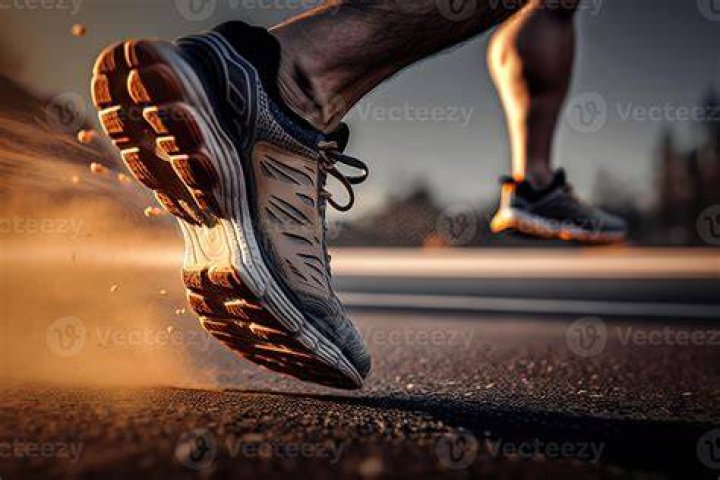 Feet of a runner on treadmill in a gym.&nbsp;Treadmill Workout: HIIT and Running Tips