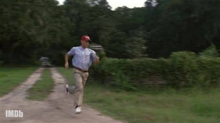 Forrest Gump Running on a highway with a crowd of people behind him and the Grand Canyon in the distance