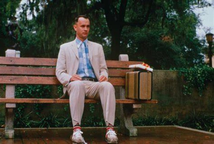 Forrest Gump's feet resting on the ground in his Nike shoes on the deck of his house