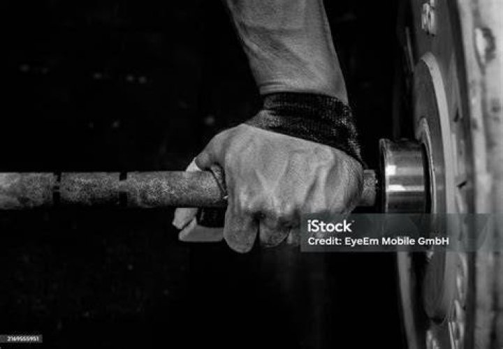Male hands with a weights for farmer's walk exercise