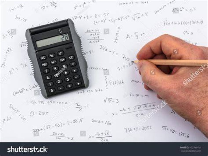 person at board doing calculations