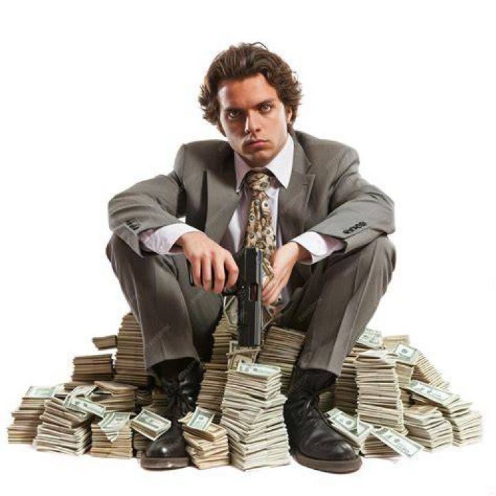 person sitting behind a pile of books
