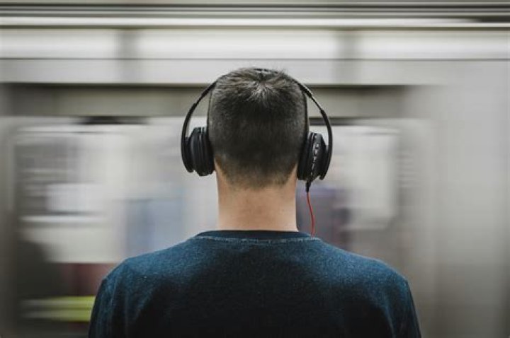 person wearing headphones taking a test in a classroom
