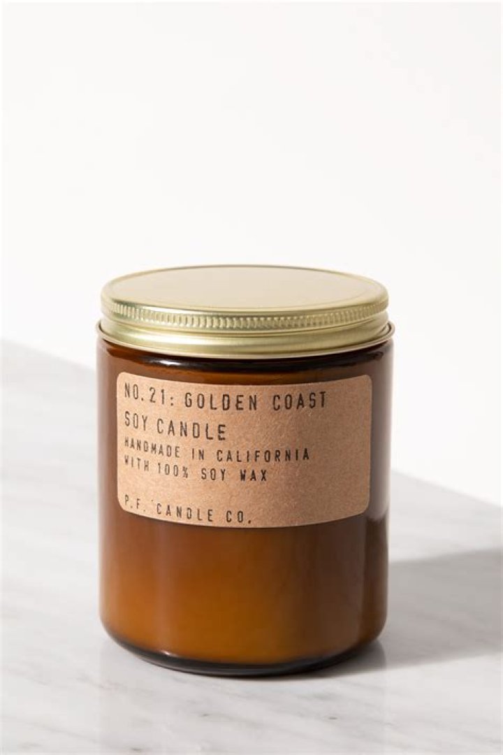 p.f. candle co golden coast long-lasting candle on a coffee table