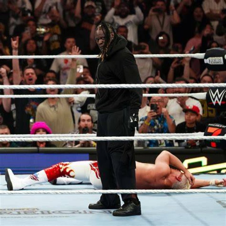 Riddle attacks Bobby Lashley with a crutch