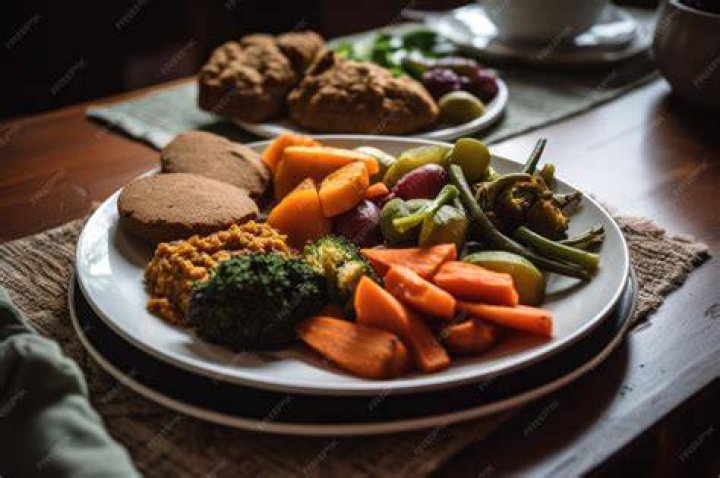 shot of a vegan meal preparation with lots of vegetables and fruits on a domestic kitchen