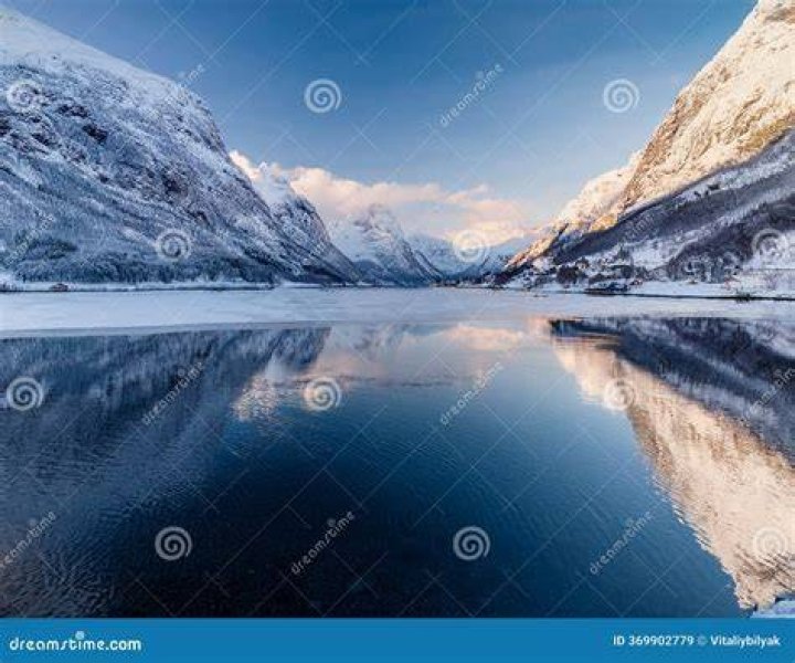 water reflecting mountains surrounded by trees and mountains